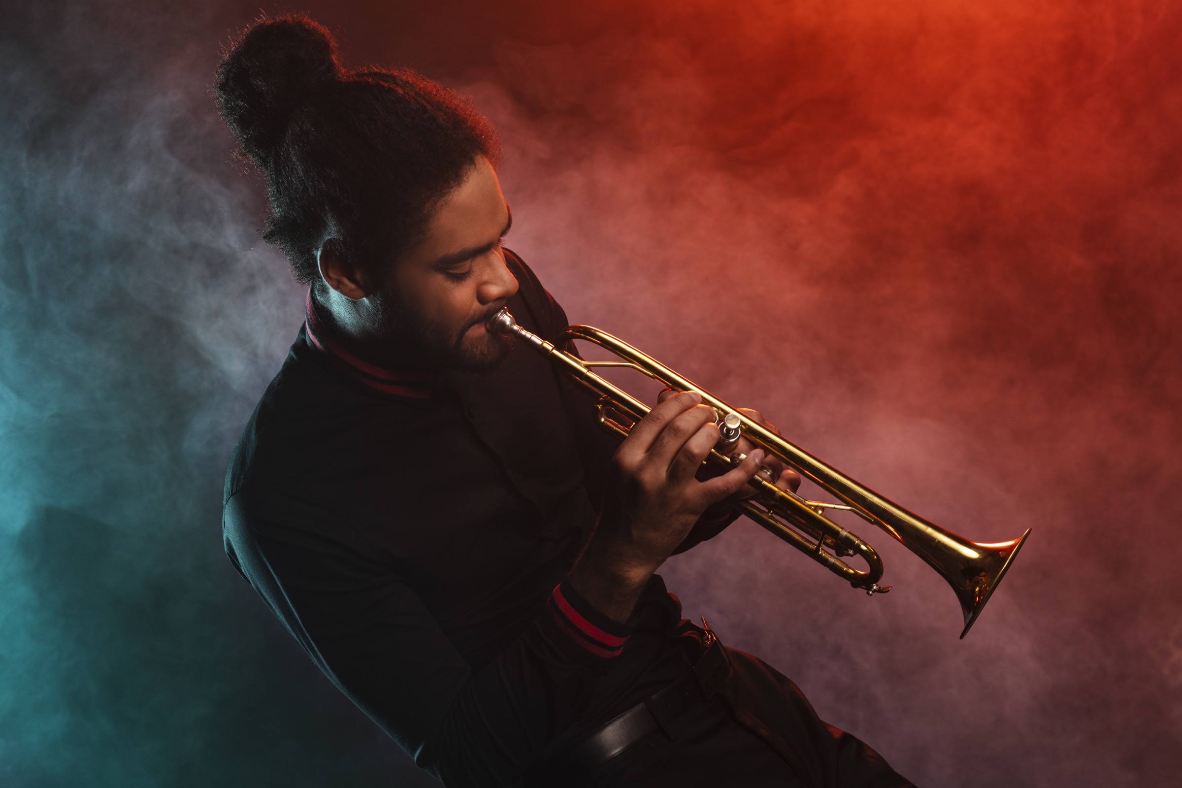 Soundhouse trumpet player performing in dramatic stage lighting